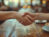 Close-up of two hands shaking, symbolizing a verbal contract in California.