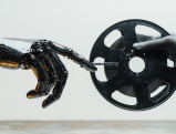 Robotic hand reaching for film reel, symbolizing AI's impact on cinema