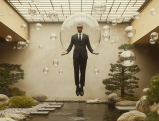 Lawyer levitating in zen garden surrounded by floating spheres