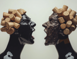 Two black wine bottle silhouettes facing each other with cork hairstyles in artistic confrontation